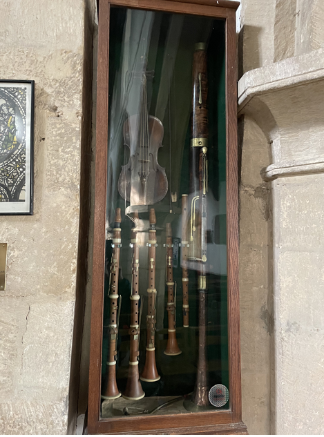 Old instruments in a glass case on the church wall